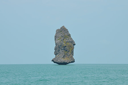 rock formation on body of water thumbnail
