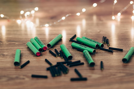 closeup photo black and green firecrackers on brown wooden surface thumbnail