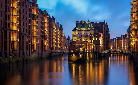 building beside calm body of water under clear sky thumbnail