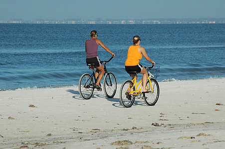 two women riding bicycles thumbnail