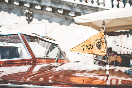 Flag on Iconic Boat Taxi in Venice, Italy thumbnail