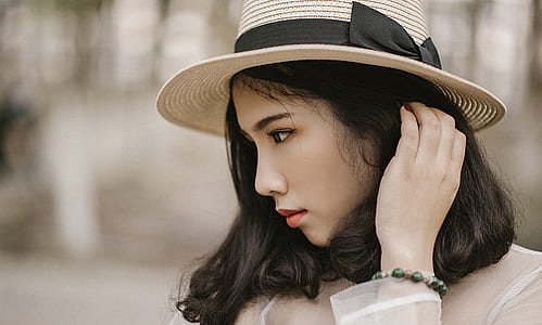 Shallow Focus Photography of Woman Wearing Brown Sun Hat thumbnail