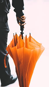 man holding orange umbrella thumbnail