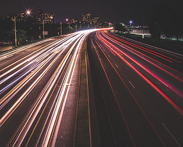 time-lapse photography of vehicles traveling on road at night time thumbnail