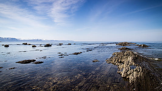 gray rocks surrounded by body of water thumbnail