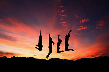 silhoutte photo of four people jumping during golden hour thumbnail