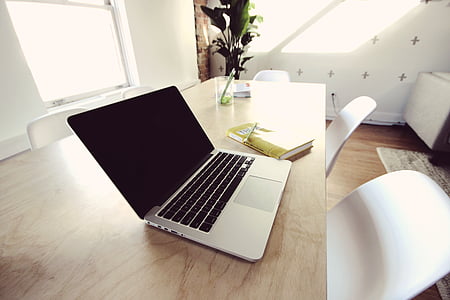 MacBook on table with chair thumbnail