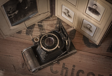 gray and black camera beside framed sketches thumbnail