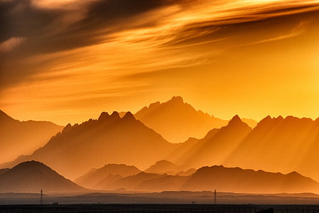silhouette of mountains during golden hour thumbnail