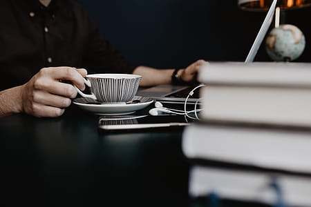Male working with a laptop and a cup of coffee thumbnail