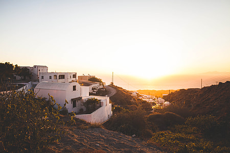 white concrete house near hill with overview of body of water thumbnail