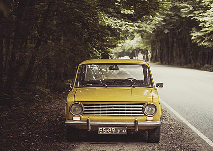 yellow car parked beside road thumbnail