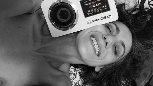 grayscale photography of woman smiling beside camera thumbnail