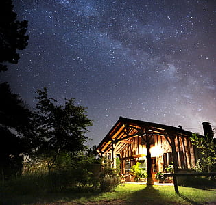 brown wooden house during night time thumbnail