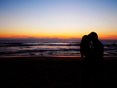 couple standing on seashore during sunset thumbnail