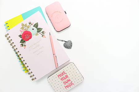 flat-lay photography of notebook beside white case thumbnail