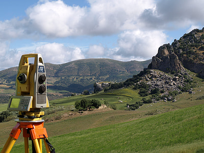 yellow and orange leveling machine near mountain during daytime thumbnail