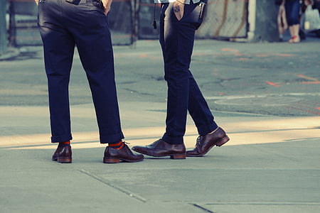 two person wearing brown leather dress shoes standing on concrete ground thumbnail