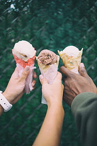person holding ice creams with cones thumbnail