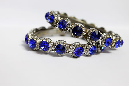 pair of silver-colored blue gemstone rings thumbnail