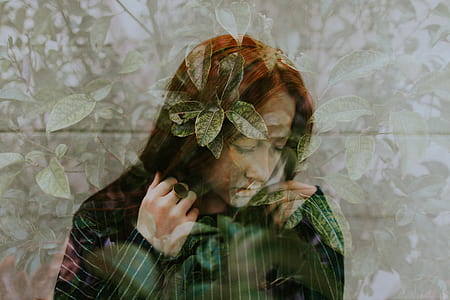 woman stands near green leaf trees thumbnail