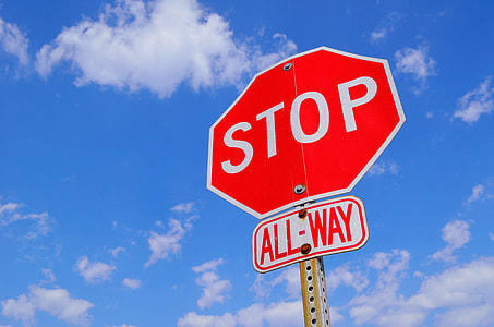 red and white Stop All-Way signage under white clouds during daytime thumbnail