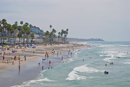people on beach during cloudy sky thumbnail