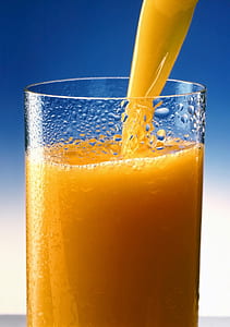 clear drinking glass with yellow liquid inside thumbnail