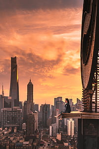 woman sitting on top brown structure thumbnail