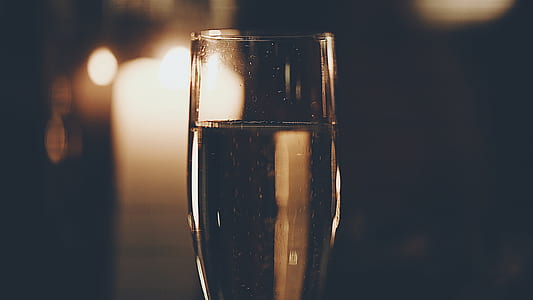 closeup photo of filled wine glass inside dark room thumbnail
