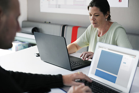 woman facing black laptop computer thumbnail