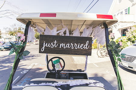 white and black golf cart with just married signage thumbnail