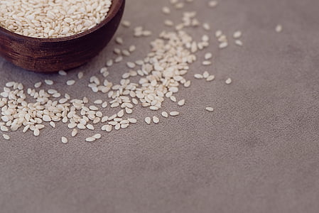 white rice on gray textile beside brown bowl thumbnail
