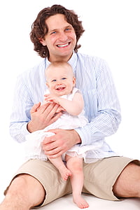 man sitting on floor holding baby girl thumbnail