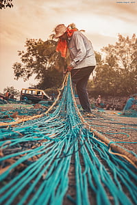 low angle photography of man holding fish net thumbnail