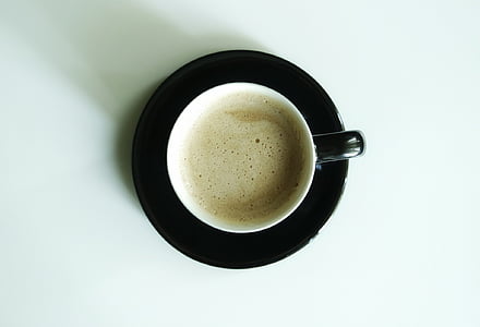 coffee on a black ceramic saucer thumbnail