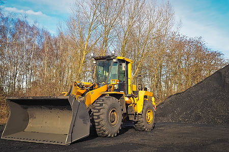 yellow front-loader near trees thumbnail
