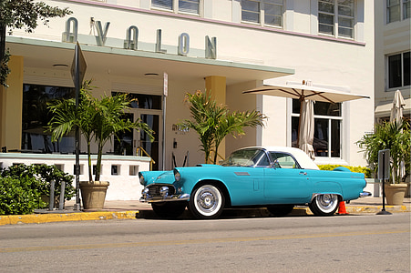 blue coupe near Ovalon building thumbnail
