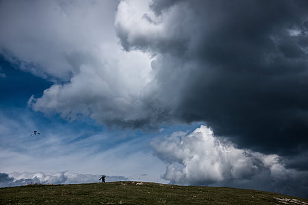 silhouette of person under white cloudy sky thumbnail