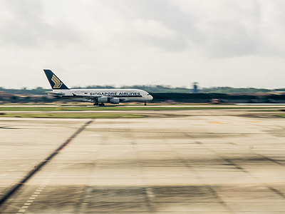 panning photography of white Singapore Airlines airliner thumbnail