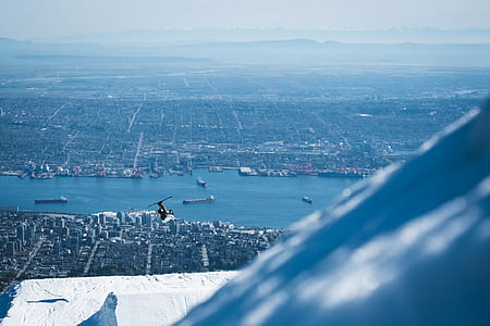 bird's eye view of helicopter flying around city thumbnail