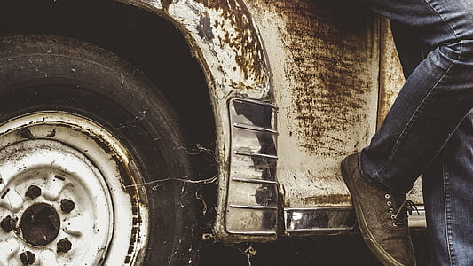 man leaning beside vehicle thumbnail