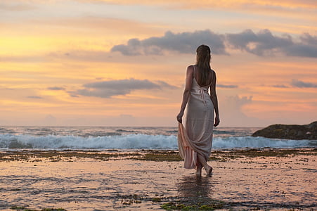 woman in white dress walking on body of water thumbnail