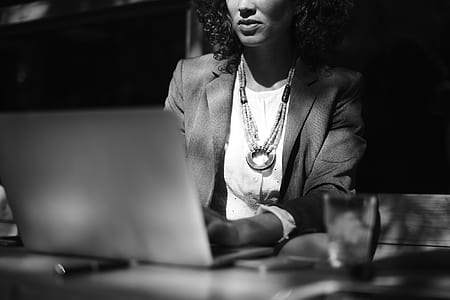 woman holding laptop sitting on chair thumbnail