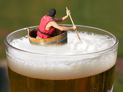 man on top of brown barrel wearing red personal flotation device thumbnail