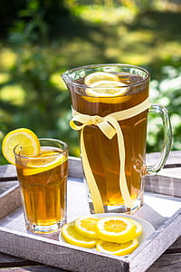 clear glass pitcher with tea inside during daytime thumbnail