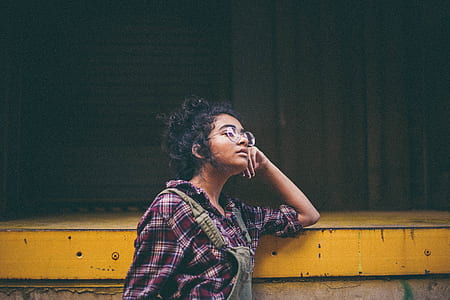 woman standing beside yellow metal frame thumbnail