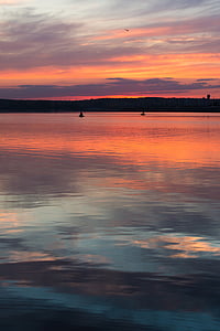 silhouette of two boats on body of water thumbnail