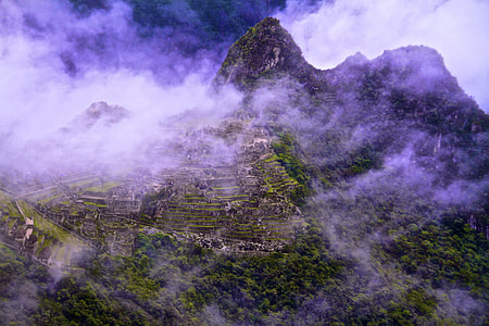 foggy green mountain under clear blue sky during daytime thumbnail
