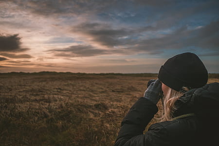 woman looking at plainfield using binoculars during daytime thumbnail